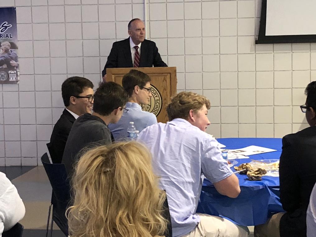 Charlie Gotch speaking as the Creighton Prep team looks on.