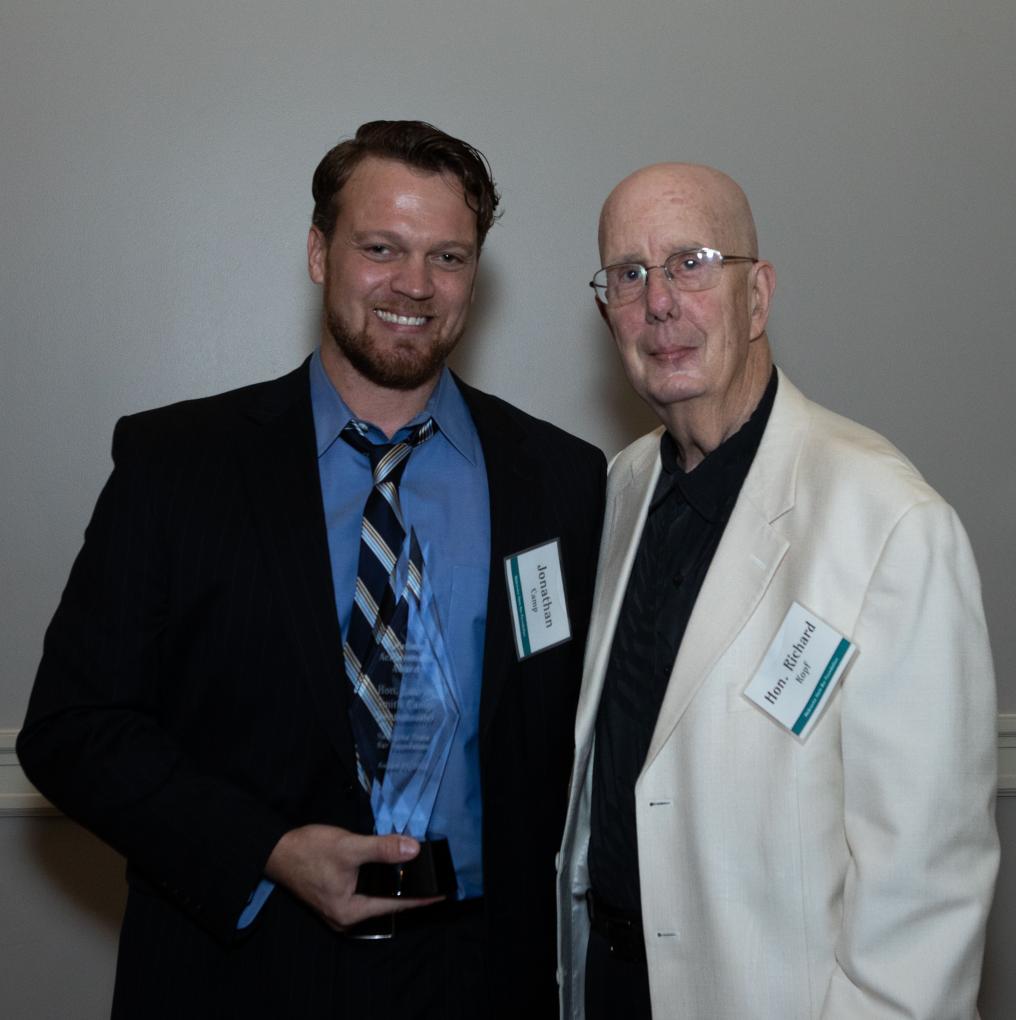 Judge Laurie Smith-Camp's son, Jonathan, accepted the award from Honorable Senior United States District Judge Rich Kopf.