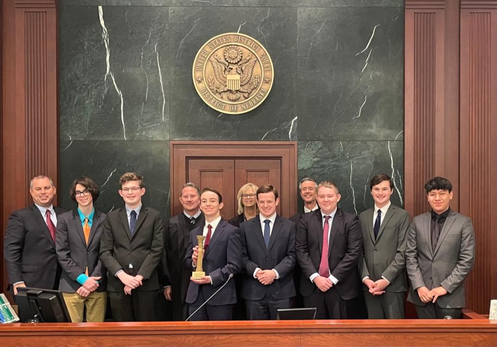 Creighton Prep students standing with their coaches, Justice Funke and Judge Bazis following the championship round.