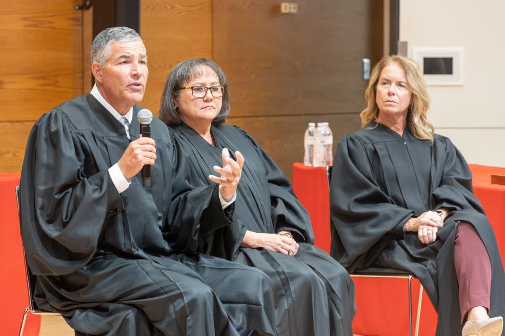 Judge Lawrence Welch, along with Presiding Judge Riko Bishop (center) and Judge Patricia Freeman (right), speaks to students at UNL